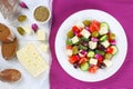 Greek salad on plate, ingredients on paper Royalty Free Stock Photo