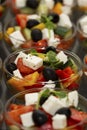 Greek salad in serving bowls. Business meetings, buffet in hotels and restaurants. Close-up. Vertical Royalty Free Stock Photo