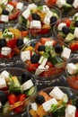 Greek salad in serving bowls. Business meetings, buffet in hotels and restaurants. Close-up. Vertical Royalty Free Stock Photo