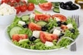 Greek salad on table in bowl with tomatoes, Feta cheese and olives Royalty Free Stock Photo