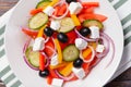 salad with tomatoes, cucumbers, olives, pepper and soft feta cheese in a plate Royalty Free Stock Photo