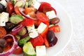 Greek Salad of tomatoes, cucumbers, sweet peppers, feta cheese, dark olives, purple onions Royalty Free Stock Photo