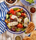 Greek salad. Traditional Greek salad consisting of fresh vegetables such as tomatoes, cucumbers, peppers, onions, oregano and oliv Royalty Free Stock Photo