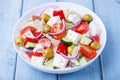 Greek salad. Traditional Greek dish. Healthy vegetarian food. Fresh vegetables and feta cheese in a white plate. Royalty Free Stock Photo