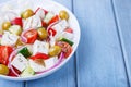 Greek salad. Traditional Greek dish. Healthy vegetarian food. Fresh vegetables and feta cheese in a white plate. Close-up. Royalty Free Stock Photo