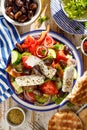 Greek salad. Traditional Greek salad consisting of fresh vegetables such as tomatoes, cucumbers, peppers, onions, oregano and oliv Royalty Free Stock Photo