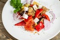 Greek salad, vegetables with cheese. Grilled vegetables eggplant, paprika, onions. Serving on a wooden Board on a rustic Royalty Free Stock Photo