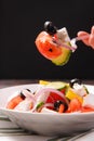Greek salad with vegetables feta and olives fork with tomato and olive