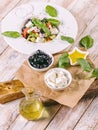 Greek salad in a white plate. Mediterranean vegetable salad with fresh basil, olives, feta cheese, olive oil and spices. Close-up Royalty Free Stock Photo