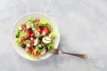 Greek salad with white wine. A plate of fresh salad with lettuce, feta cheese, tomatoes etc Royalty Free Stock Photo