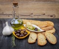 Greek sauce in white bowl & Greek olives on wood background. Olive oil and spices. Bread dipping concept Royalty Free Stock Photo
