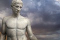 Greek Sculpture. Young Adonis bronze statue with blue sky background