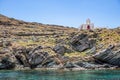 Small chapel, Greek Church on the rocky hill by the sea, blue sky background. Kythnos island, Greece Royalty Free Stock Photo