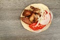 Greek souvlaki with pita bread and vegetables close-up on the table. Pork table Royalty Free Stock Photo