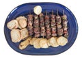 Greek souvlaki and potates on the plate isolated