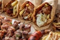 Greek street food, gyro sliced meat pita bread wrap and souvlaki skewer, overhead