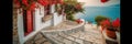 Greek street, whitewashed houses, beautiful red liana flowers, path to the sea