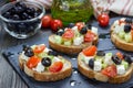 Greek style crostini with feta cheese, tomatoes, cucumber, olives, herbs Royalty Free Stock Photo