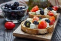 Greek style crostini with feta cheese, tomatoes, cucumber, olives, herbs Royalty Free Stock Photo