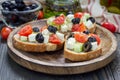 Greek style crostini with feta cheese, tomatoes, cucumber, olives, herbs Royalty Free Stock Photo