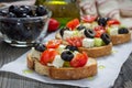 Greek style crostini with feta cheese, tomatoes, cucumber, olives, herbs Royalty Free Stock Photo