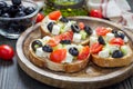 Greek style crostini with feta cheese, tomatoes, cucumber, olives, herbs Royalty Free Stock Photo
