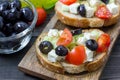 Greek style crostini with feta cheese, tomatoes, cucumber, olives, herbs Royalty Free Stock Photo