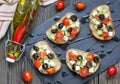 Greek style crostini with feta cheese, tomatoes, cucumber, olives and herbs Royalty Free Stock Photo