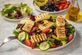 Greek style cuisine - salad with grilled halloumi cheese, avocado, pecan nuts and tomatoes. Royalty Free Stock Photo