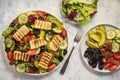 Greek style cuisine - salad with grilled halloumi cheese, avocado, pecan nuts and tomatoes. Royalty Free Stock Photo