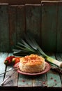 Greek style pastry with phyllo dough. Homemade pie with raw vegetables and pomegranate seeds on shabby blue background copy space