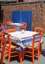 Greek tavern with orange wooden chairs by the sea coast, Greece, Royalty Free Stock Photo