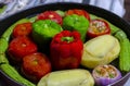 Greek traditional food Gemista in round oven tray ready to be cooked. Stuffed peppers, tomatoes, zucchini, potatoes and onion wit