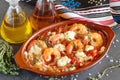 Oven backed prawns with feta, tomato, paprika, thyme in a traditional ceramic form on a abstract background. Healthy eating concep Royalty Free Stock Photo