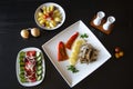 Greek traditional fried anchovies gavros with a sliced lemon on a plate, greek salad and boiled potatoes islolated