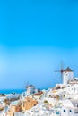 Greek Traditional White Houses and Windmills of Oia or Ia at Santorini Island in Greece at Noon Royalty Free Stock Photo