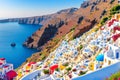 Greek Traveling Concepts include Sailing Boats near Volcanic Slopes of Santorini Oia or Ia Village in Greece Enjoying Su