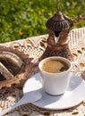 Greek Turkish brewed coffee and marble halva on a table with a handmade tablecloth and a copper coffee maker and candy maker on Royalty Free Stock Photo