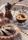 Greek Turkish brewed coffee and marble halva on a table with a handmade tablecloth and a copper coffee maker and candy maker on Royalty Free Stock Photo