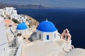 Greek white churchs with blue domes overlooking the sea, Oia, Santorini, Cyclades Islands, Greece