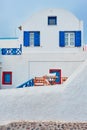 Greek white house with blue door and window blinds Oia village on Santorini island in Greece Royalty Free Stock Photo