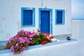 Greek white house with blue door and window blinds Oia village on Santorini island in Greece Royalty Free Stock Photo