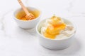 Greek yoghurt with honey on marble table Royalty Free Stock Photo