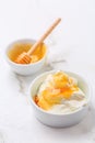 Greek yoghurt with honey on marble table Royalty Free Stock Photo