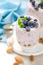 Greek yogurt or blueberry parfait with fresh berries and almond nuts on white background Royalty Free Stock Photo