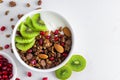 Greek yogurt with chocolate granola, kiwi fruit, pomegranate seeds and almonds in a bowl Royalty Free Stock Photo