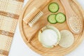 Greek yogurt, cucumber slices, wooden hair brush, massage body brush and loofah sponge. Ingredients for preparing homemade mask