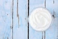 Greek yogurt, downward view on rustic blue wood