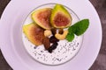 Greek yogurt with figs, nuts and honey in a bowl. Close-up. View from above.