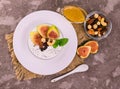 Greek yogurt with figs, nuts and honey in a bowl on a gray background. View from above.